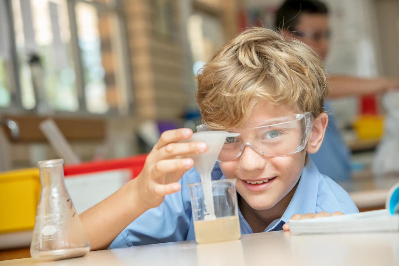 Student conducting a science experiment with lab equipment supporting hands on learning inquiry and scientific thinking