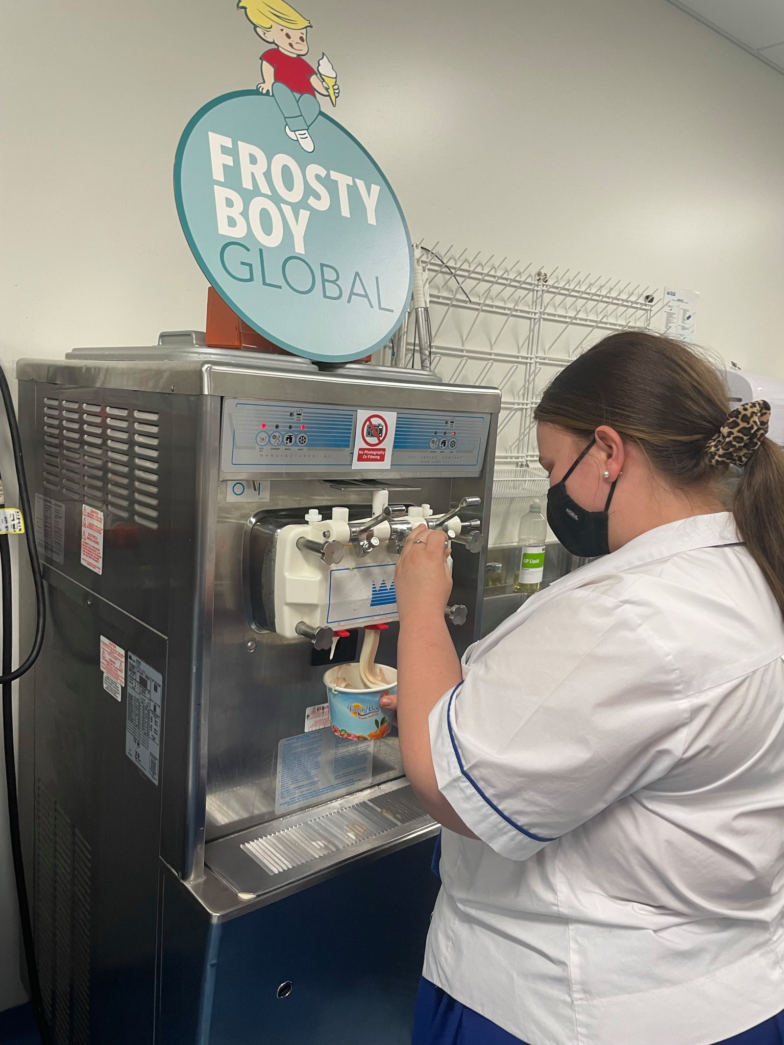 Student preparing frozen dessert using commercial equipment supporting hospitality training and practical workplace skills