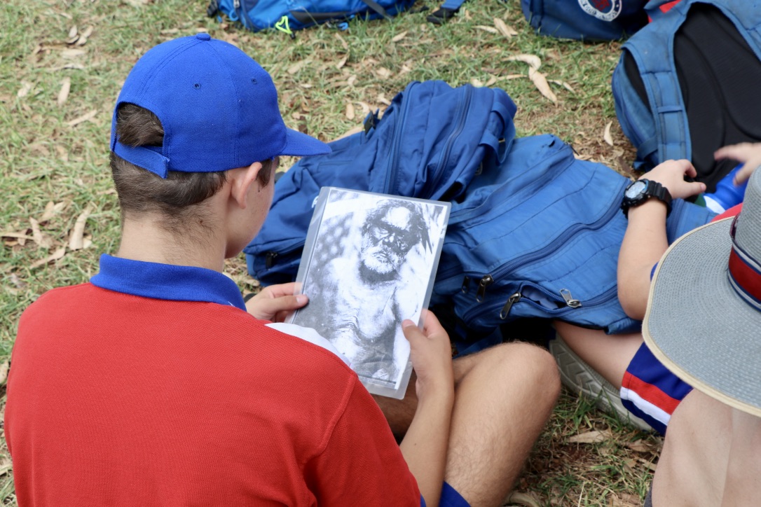 Students reviewing learning materials outdoors supporting cultural learning reflection and engagement with curriculum content