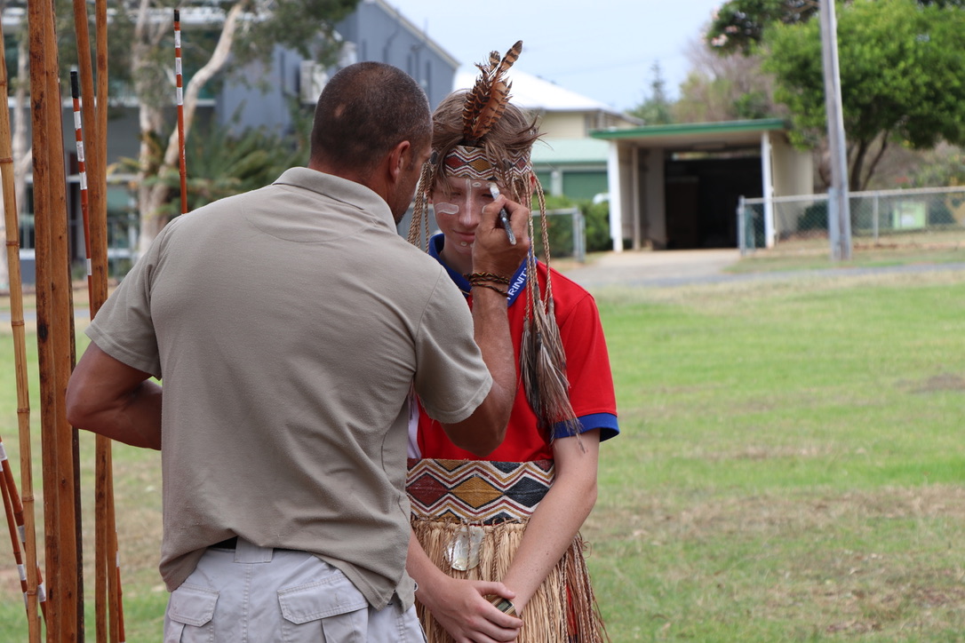 Student participating in a cultural learning activity with traditional face painting highlighting respect for First Nations culture and identity